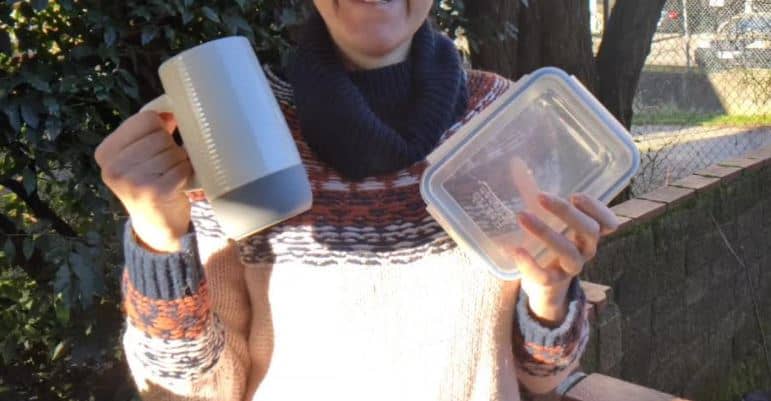 Woman holding reusable containers for food and beverage.Goin Green New WestProject