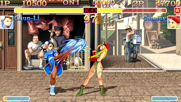 Scene of the game Street Fighter where Chun-Li is beating Cammy and kicking her face
